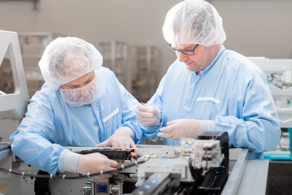 Technicians in the cleanroom working on a positioning stage